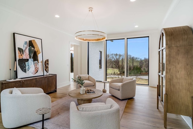 living room featuring ornamental molding and light wood-type flooring