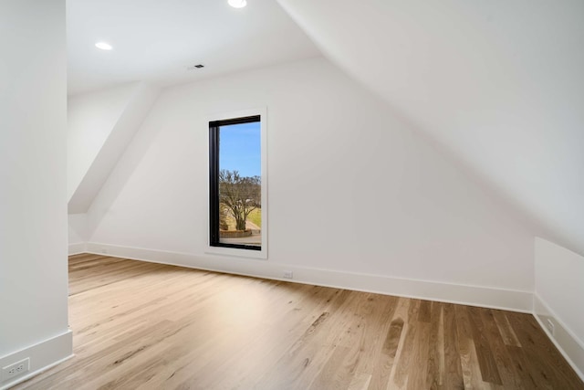 bonus room with light hardwood / wood-style flooring and vaulted ceiling