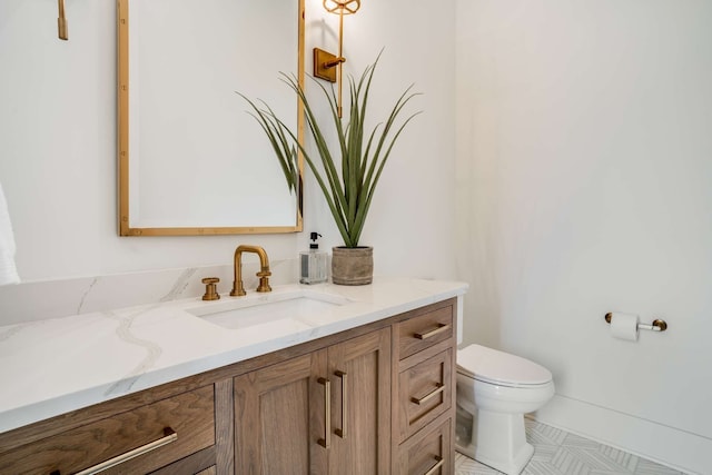 bathroom with tile floors, toilet, and vanity