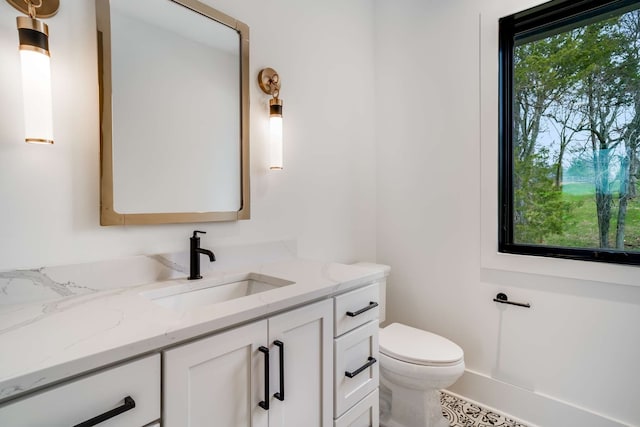 bathroom featuring vanity, tile floors, and toilet