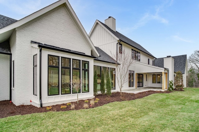 rear view of house with a yard