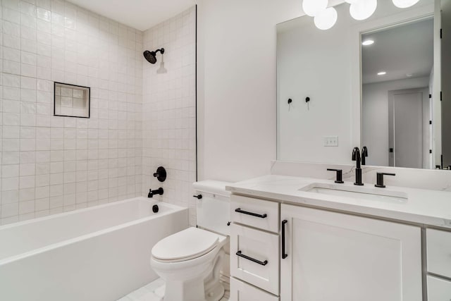 full bathroom featuring tiled shower / bath combo, toilet, tile floors, and vanity with extensive cabinet space