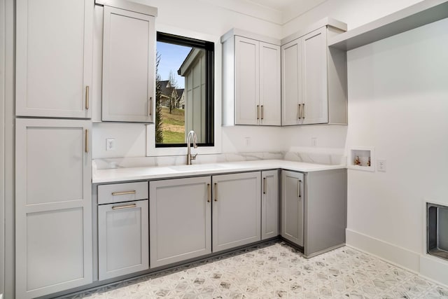 kitchen featuring sink, gray cabinetry, and light tile floors