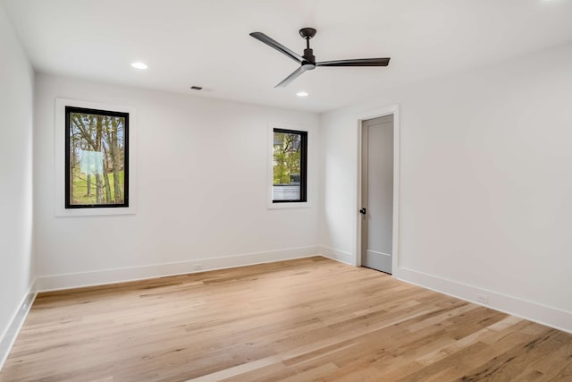 unfurnished room with ceiling fan, light hardwood / wood-style floors, and plenty of natural light