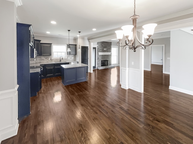 kitchen featuring an inviting chandelier, hanging light fixtures, dark hardwood / wood-style floors, and a healthy amount of sunlight