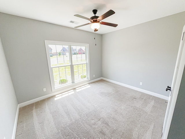 carpeted spare room featuring ceiling fan