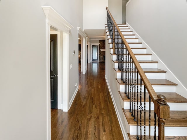 stairs with dark hardwood / wood-style flooring