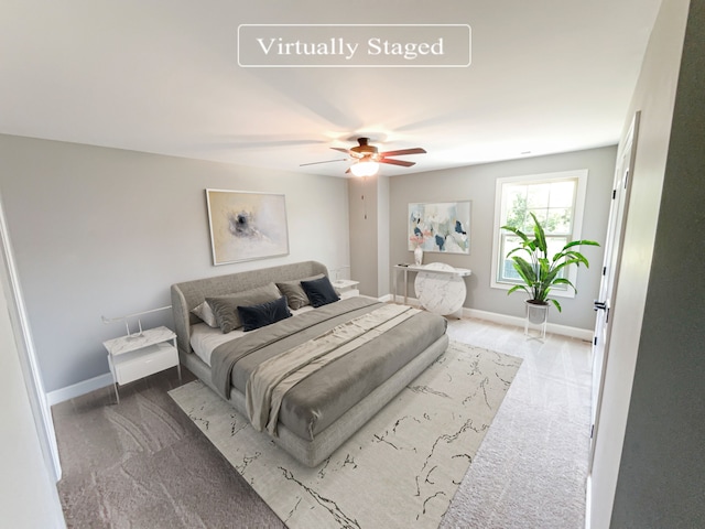 bedroom featuring ceiling fan and light carpet