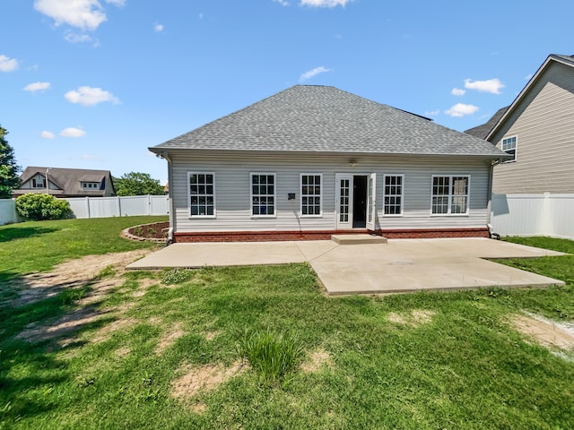 back of house featuring a patio area and a lawn