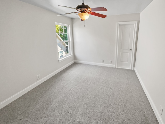 carpeted empty room with ceiling fan