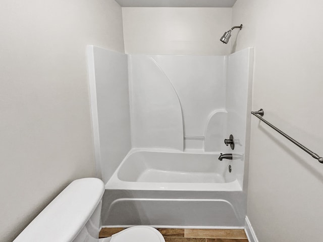 bathroom with tile floors, bathtub / shower combination, and toilet