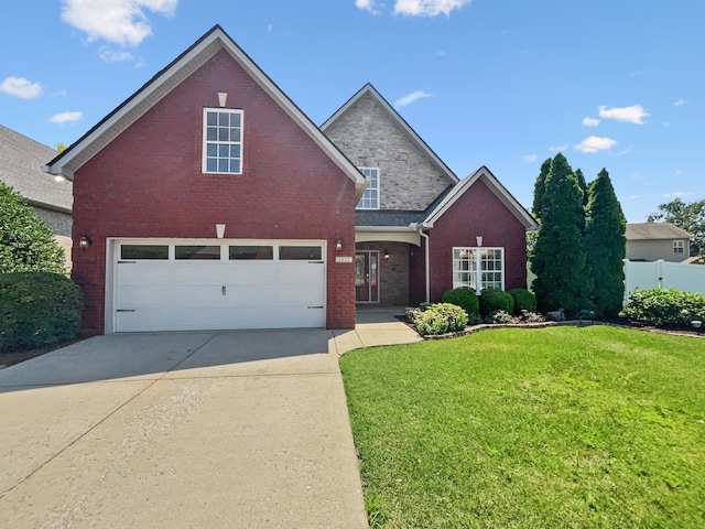 view of property featuring a front lawn and a garage