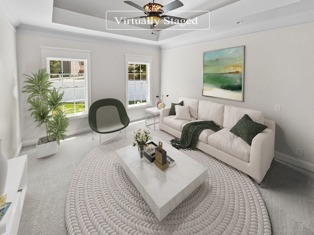 carpeted living room with a raised ceiling and ceiling fan