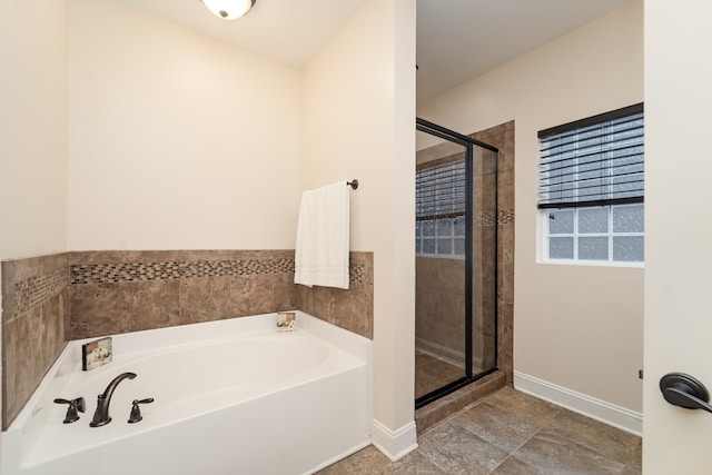 bathroom with tile floors and independent shower and bath