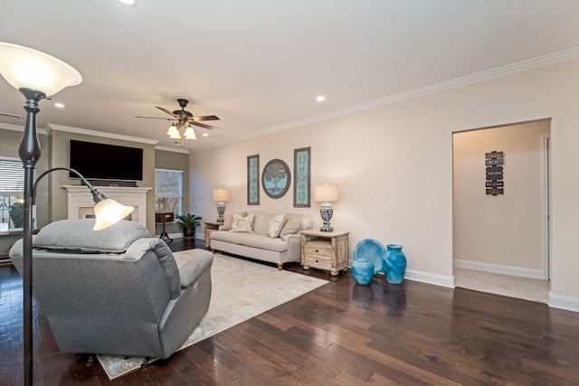 living room featuring ceiling fan, ornamental molding, and dark hardwood / wood-style flooring