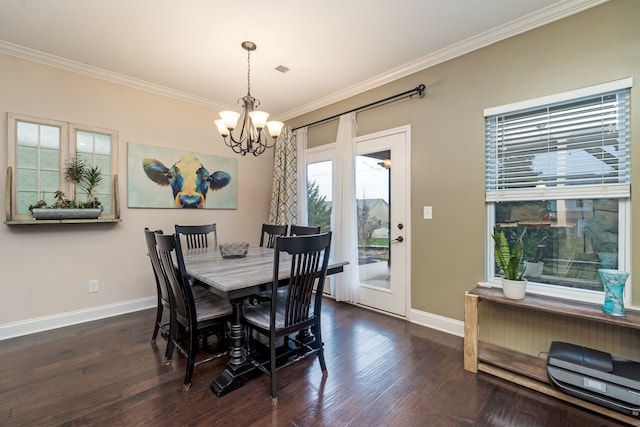 dining area with dark hardwood / wood-style flooring, an inviting chandelier, ornamental molding, and a wealth of natural light