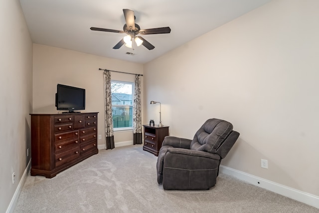 sitting room featuring light carpet and ceiling fan