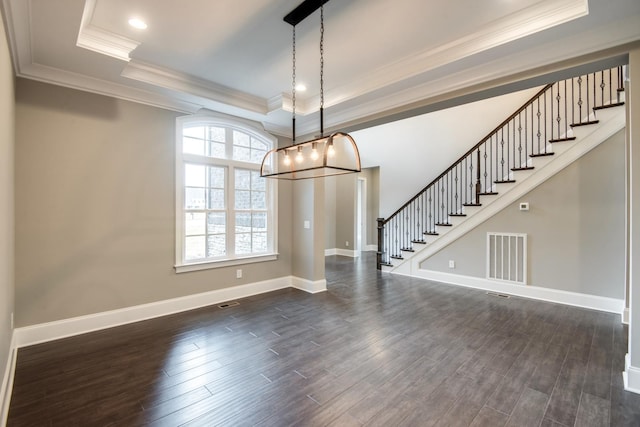 unfurnished dining area featuring a raised ceiling, dark hardwood / wood-style flooring, and a notable chandelier