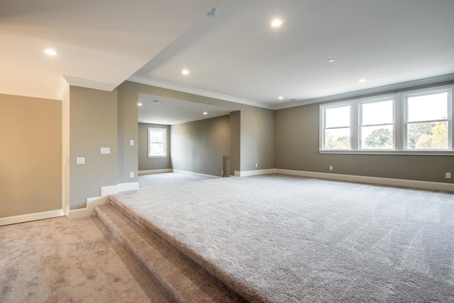 unfurnished room with crown molding and light carpet