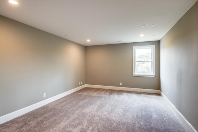 unfurnished room featuring light colored carpet