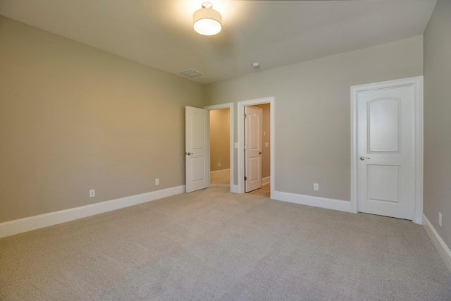 unfurnished bedroom featuring light colored carpet