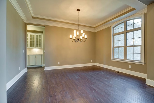 unfurnished room with plenty of natural light, a notable chandelier, ornamental molding, and dark hardwood / wood-style floors