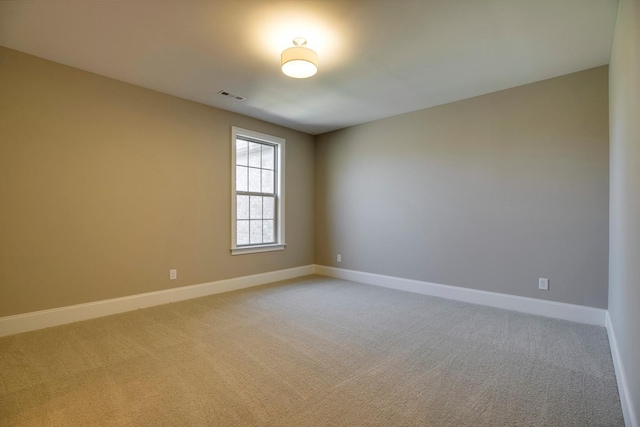 unfurnished room featuring light colored carpet