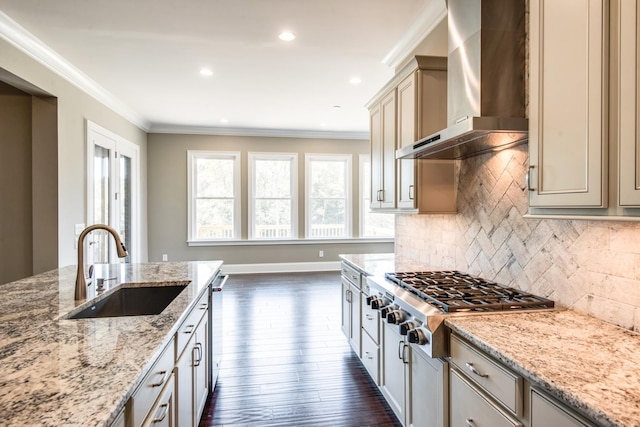 kitchen with sink, dark hardwood / wood-style flooring, light stone countertops, wall chimney exhaust hood, and tasteful backsplash