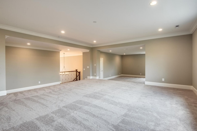 empty room with crown molding and light colored carpet