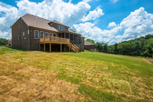 back of house with a deck and a lawn