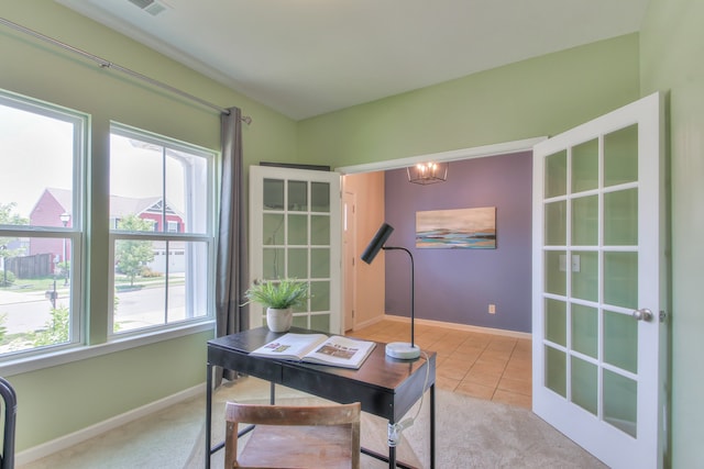 carpeted office featuring an inviting chandelier and french doors