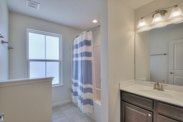 bathroom featuring shower / bath combo with shower curtain, vanity, and tile flooring