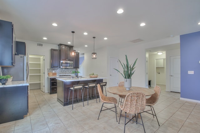 tiled dining area featuring sink