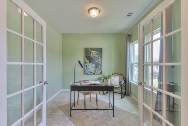 home office with light colored carpet and french doors