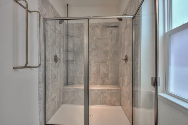 bathroom with a shower with door