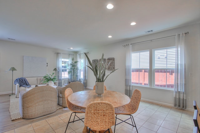 tiled dining space featuring plenty of natural light