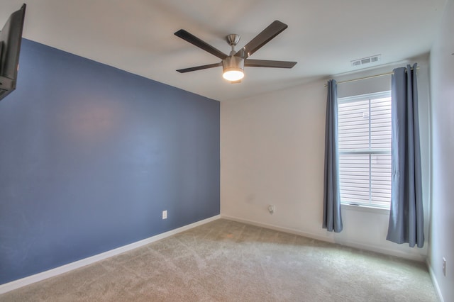 carpeted empty room featuring ceiling fan