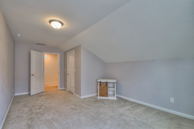 additional living space with lofted ceiling and light colored carpet