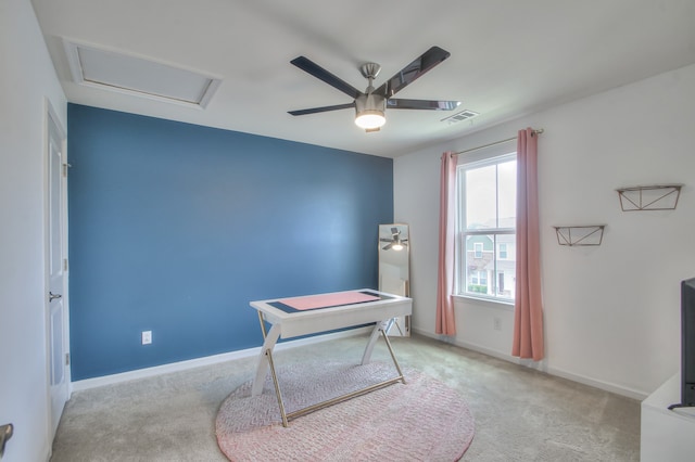 carpeted office space with ceiling fan