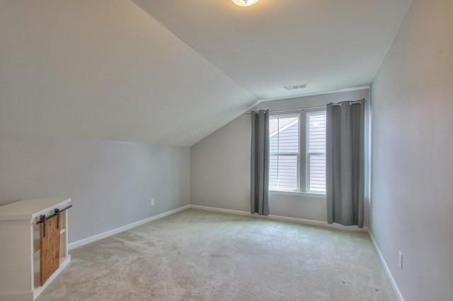 additional living space with lofted ceiling and light colored carpet