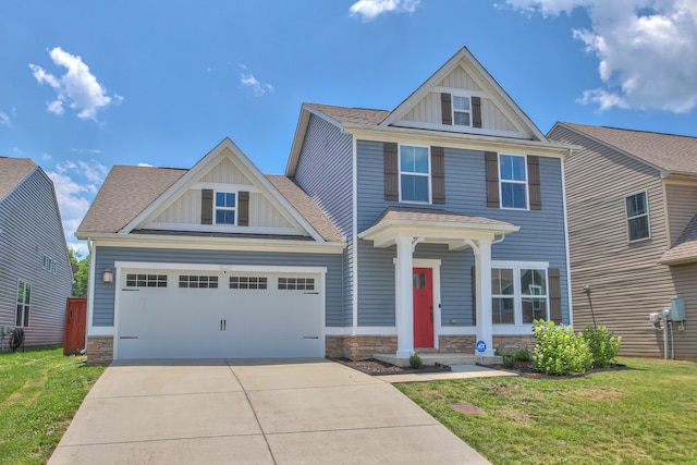 craftsman inspired home with a front yard and a garage