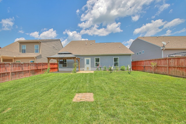 back of house featuring a gazebo, a patio area, and a lawn