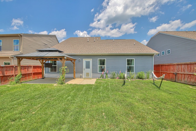 back of property featuring a gazebo, a yard, and a patio area