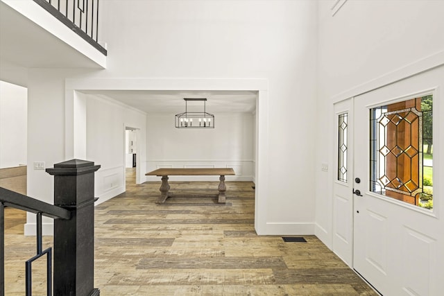 foyer with a chandelier and hardwood / wood-style floors