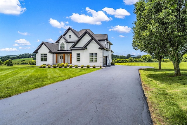 view of front of home with a front lawn and a garage