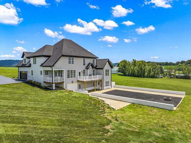 back of house featuring a lawn and a garage