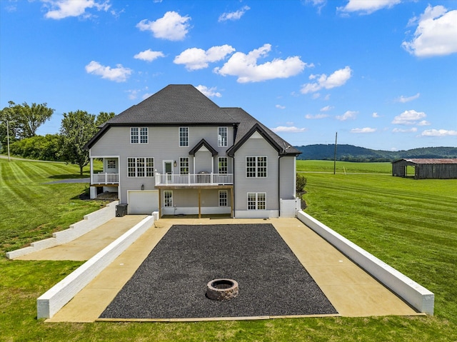 rear view of house with a lawn and a garage