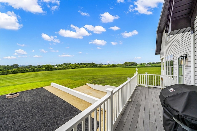 wooden deck featuring a patio, grilling area, and a yard