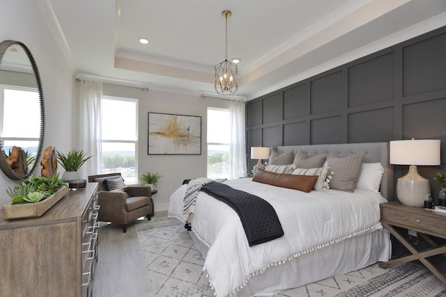 bedroom with an inviting chandelier and a raised ceiling