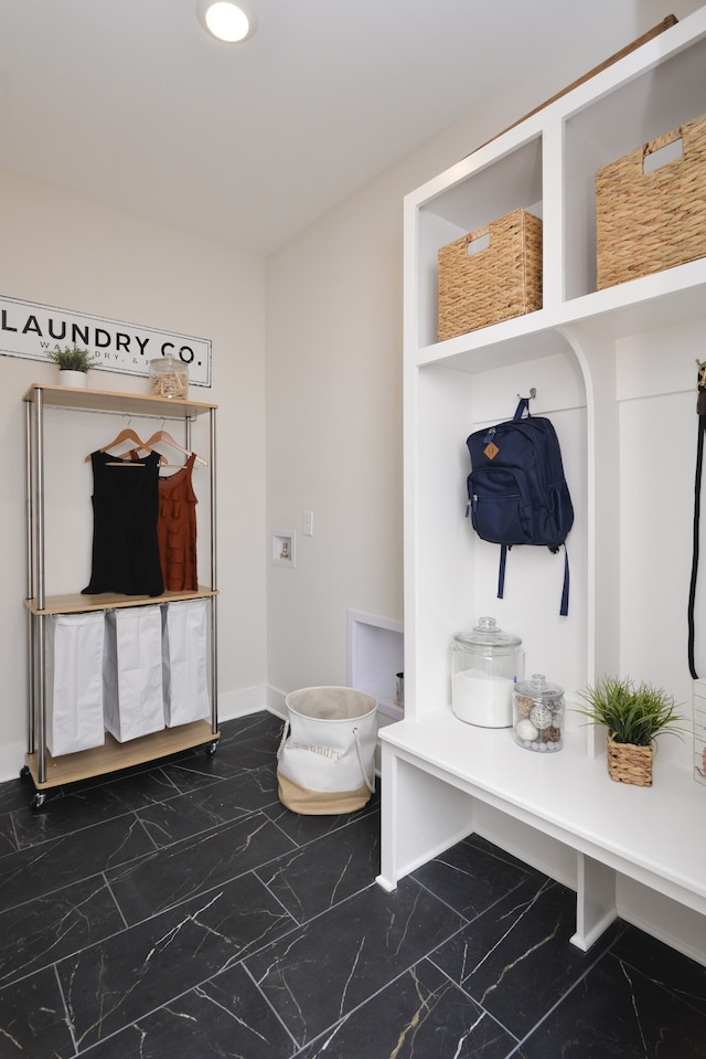 mudroom featuring dark tile flooring